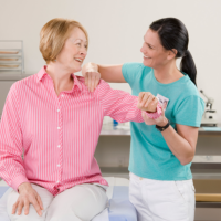 caregiver massaging the shoulder of patient