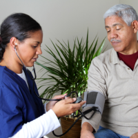 caregiver getting blood pressure of patient