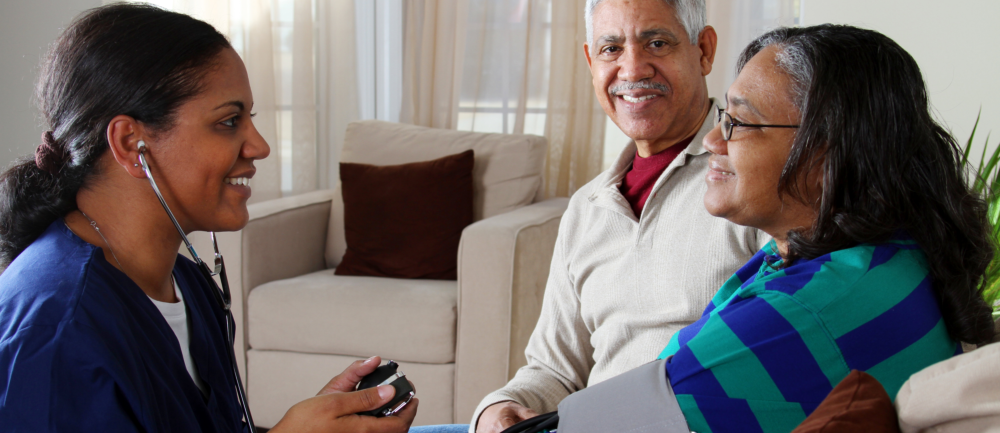 caregiver getting the blood pressure of female patient