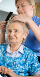 caregiver combing the hair of patient