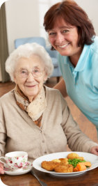 caregiver serving foods to patient